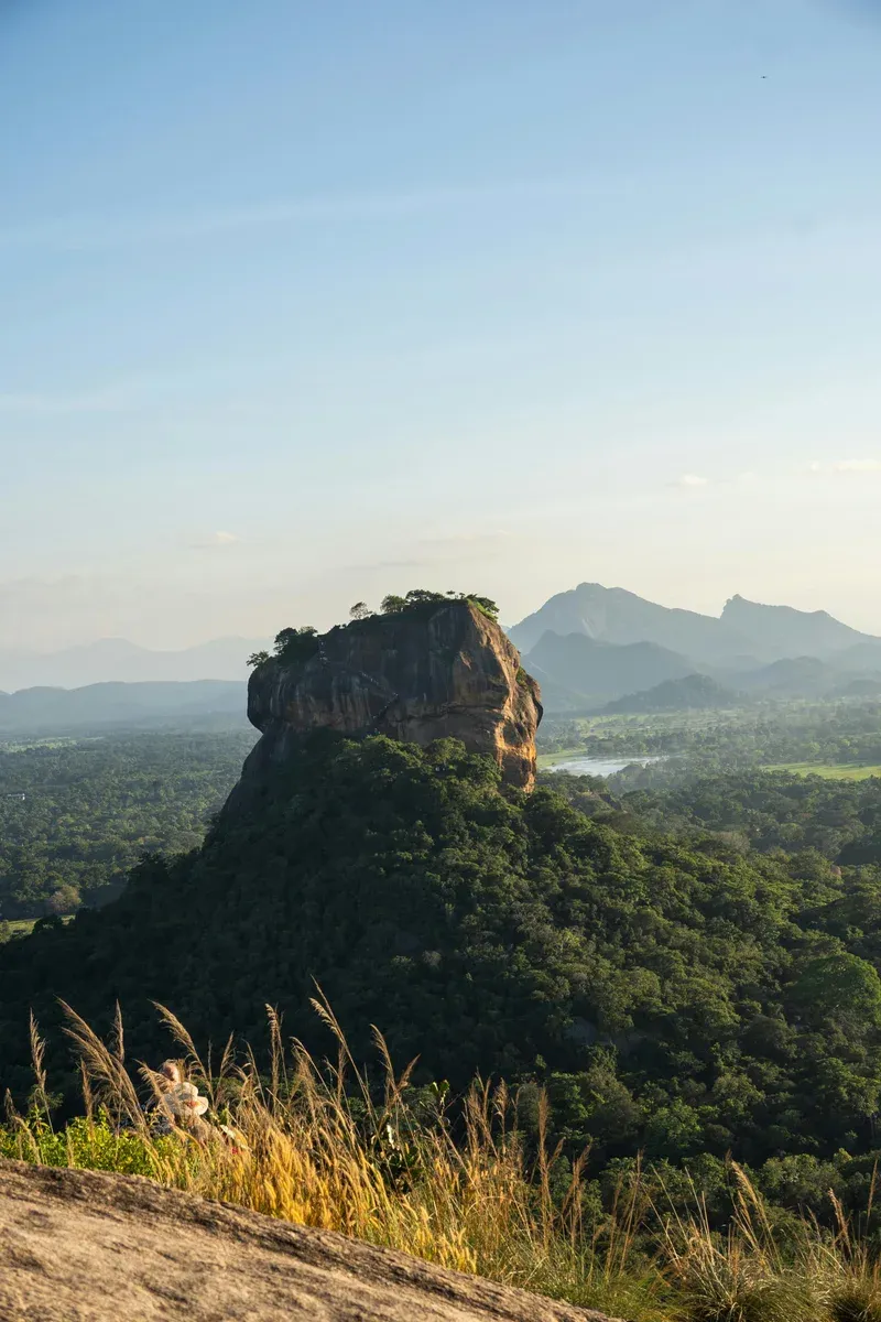 Sigiriya rock rising above the forest canopy